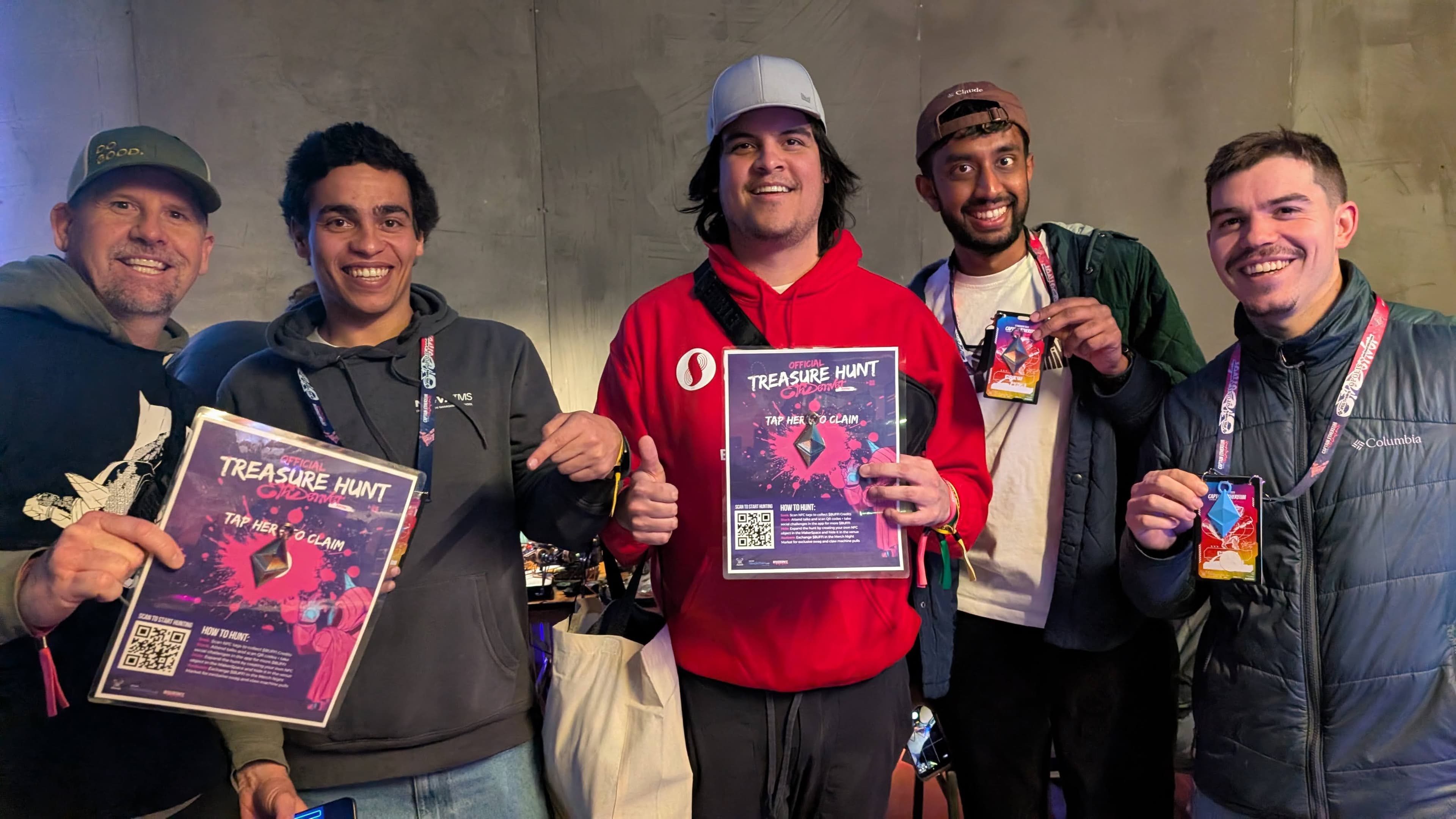 Attendees holding Official Treasure Hunt flyers with tap-to-claim QR codes at the event booth